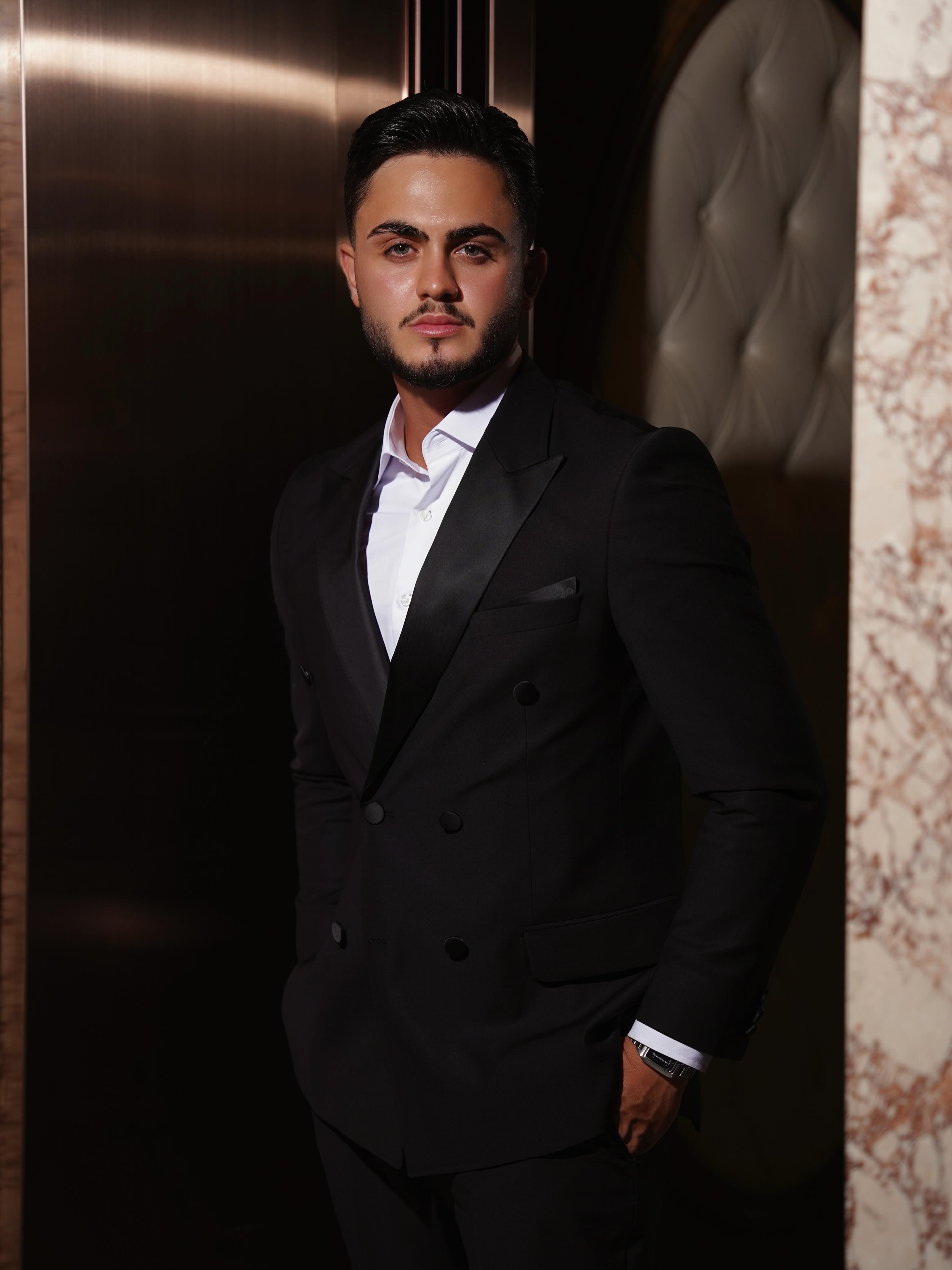Mahmoud Maher in a black suit